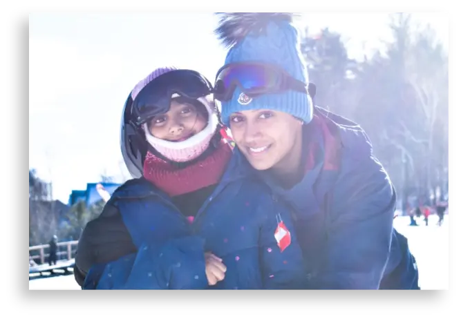 Smiling skiers standing on the slopes of Bousquet Mountain