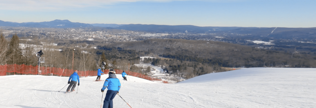 Skiers heading down slopes on Bousquet Mountain
