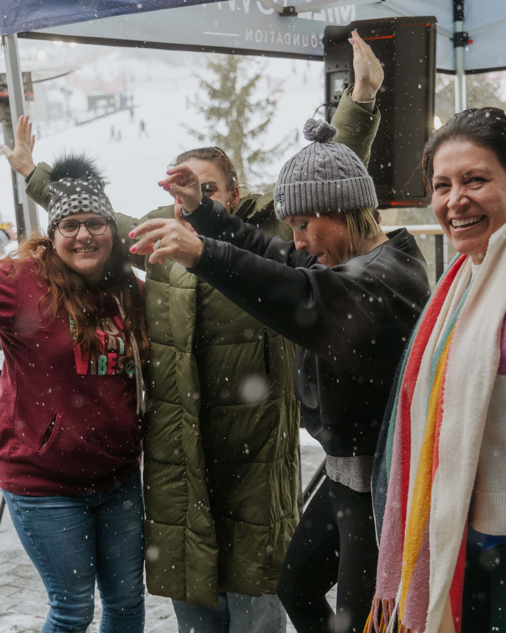 Four women dancing on the deck at Bousquet Mountain's DJ on the Deck series.
