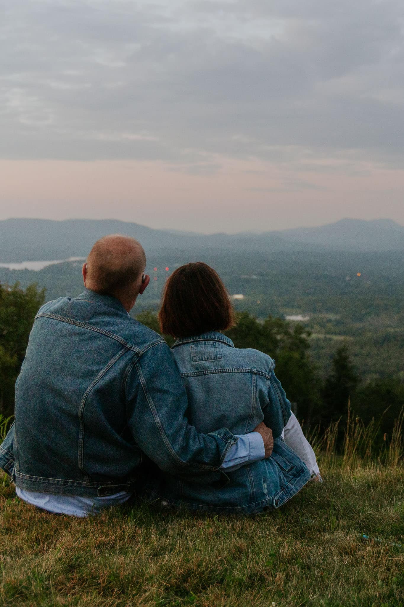 a couple sitting on the edge of a mountain at bousquet in pittsfield massachusetes
